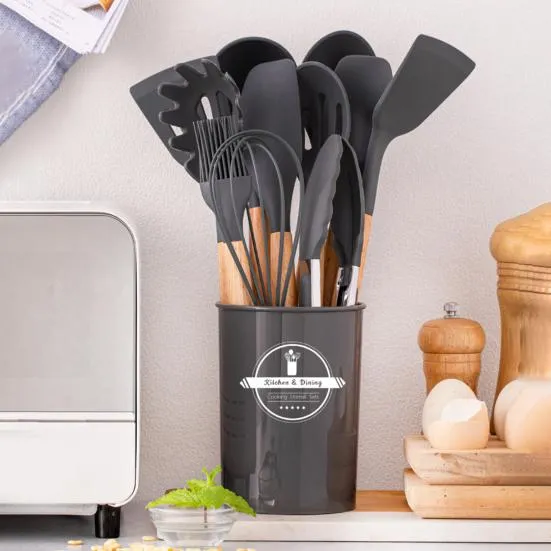 12 Pcs Silicone Cooking Utensils Set in black with wooden handles in utensil holder on kitchen counter