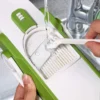 Easy-to-clean adjustable vegetable slicer being rinsed under water with cleaning brush