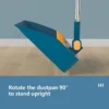 Adjustable dustpan standing upright at 90-degree angle for space-saving storage