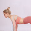 Woman using adjustable silicone chest expander in push-up position for full body resistance training