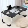 Multipurpose laptop table with foldable legs, holding laptop, tablet, keyboard, and coffee cup