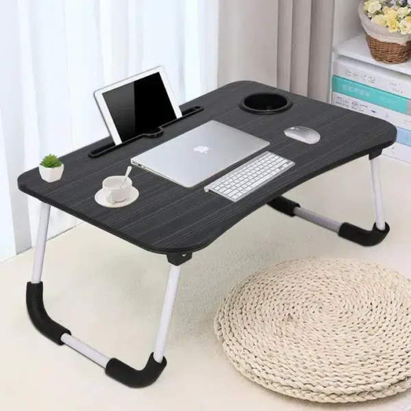 Multipurpose laptop table with foldable legs, holding laptop, tablet, keyboard, and coffee cup