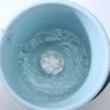 Mini ultrasonic turbine washing machine creating powerful water swirl in bucket