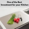 Stainless steel cutting board with tomatoes, greens, and kitchen knife