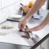 Rolling dumpling dough with rolling pin on the board