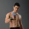 Fit, shirtless athlete demonstrating an adjustable blue hand grip strengthener to train forearm and finger grip strength