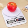 Red apple on digital kitchen scale showing weight in grams