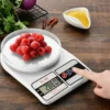 Digital kitchen scale with fresh raspberries showing weight in grams
