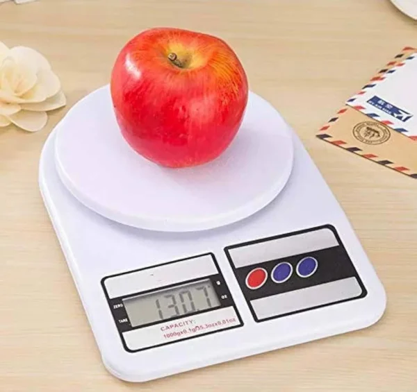 Red apple on digital kitchen scale showing weight in grams