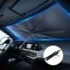 Foldable car sunshade umbrella installed on windshield to protect dashboard from sunlight and heat