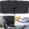 Car sunshade umbrella unfolded on windshield with outside and inside view for sun protection